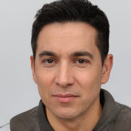 Joyful white adult male with short  black hair and brown eyes