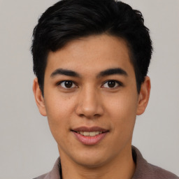 Joyful asian young-adult male with short  black hair and brown eyes