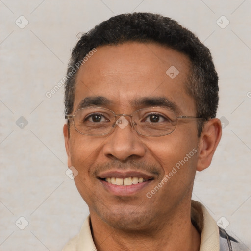 Joyful latino adult male with short  black hair and brown eyes