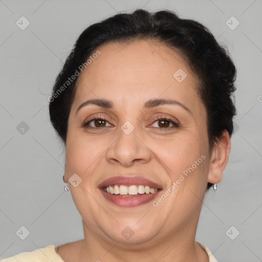 Joyful latino adult female with short  brown hair and brown eyes