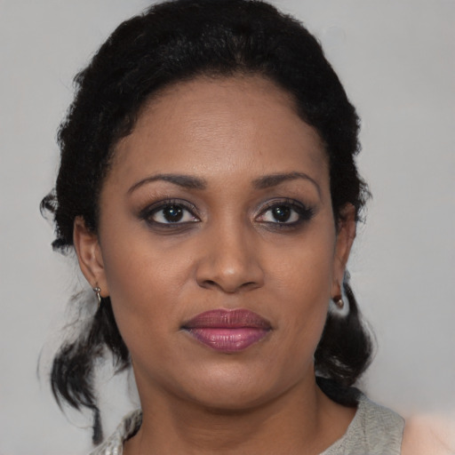 Joyful black young-adult female with medium  black hair and brown eyes