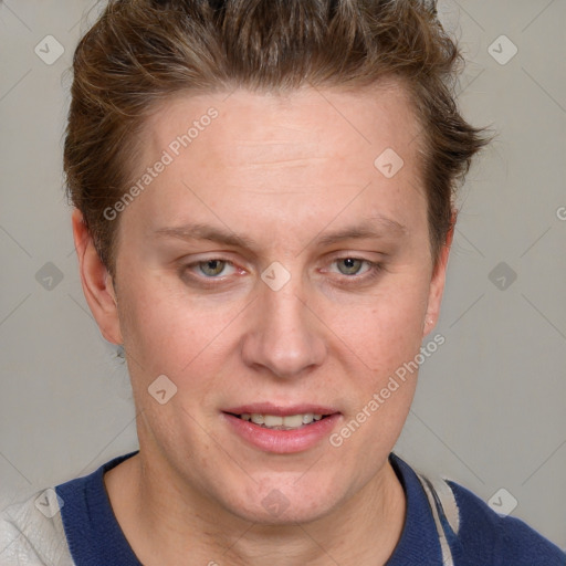 Joyful white adult female with short  brown hair and blue eyes