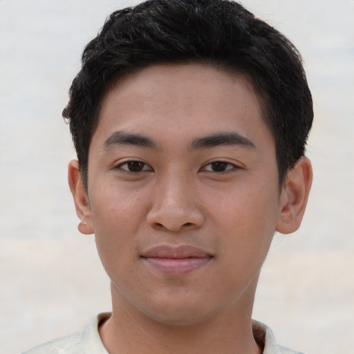 Joyful asian young-adult male with short  brown hair and brown eyes