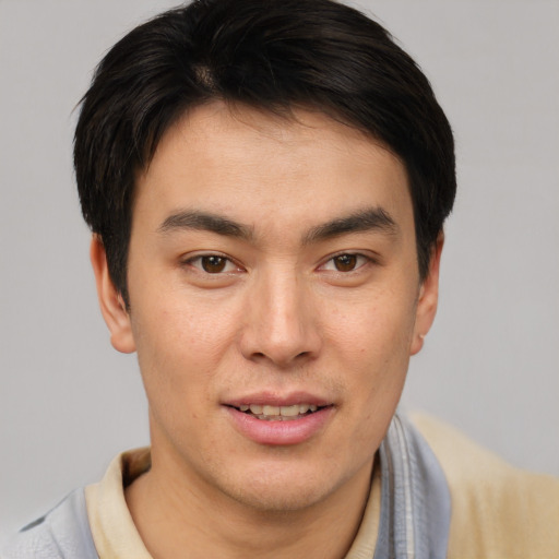 Joyful asian young-adult male with short  brown hair and brown eyes