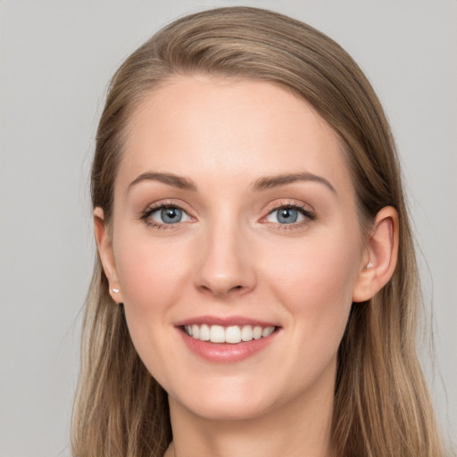 Joyful white young-adult female with long  brown hair and grey eyes