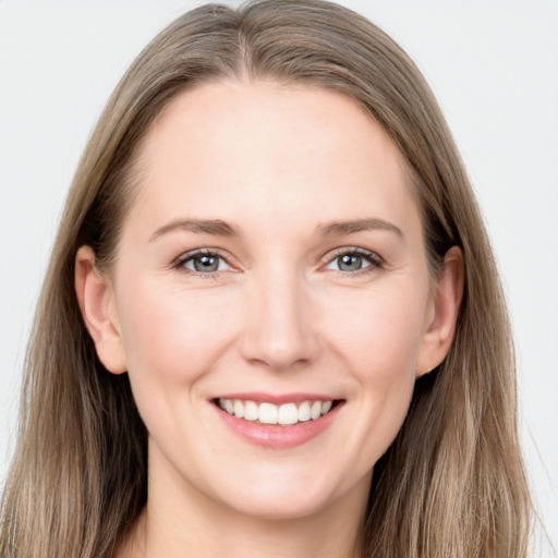 Joyful white young-adult female with long  brown hair and grey eyes