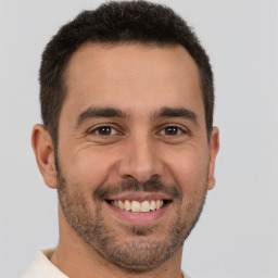 Joyful white young-adult male with short  brown hair and brown eyes