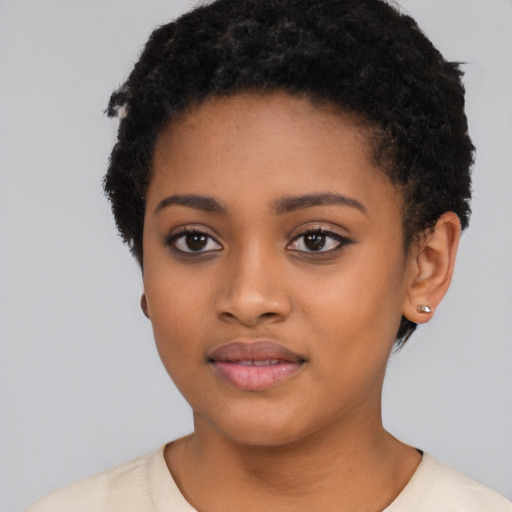 Joyful black young-adult female with short  black hair and brown eyes