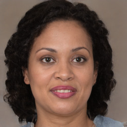 Joyful black adult female with medium  brown hair and brown eyes