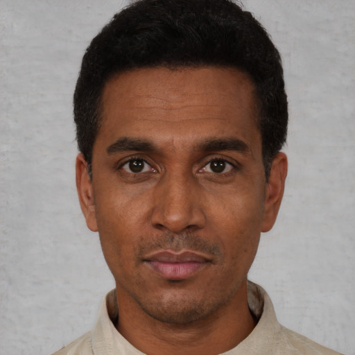 Neutral latino adult male with short  black hair and brown eyes