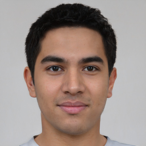 Joyful white young-adult male with short  black hair and brown eyes