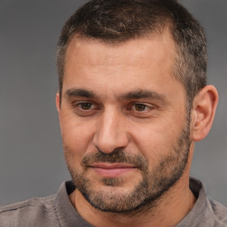 Joyful white adult male with short  brown hair and brown eyes