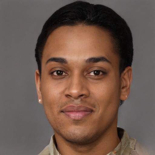 Joyful black young-adult male with short  brown hair and brown eyes