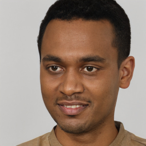 Joyful black young-adult male with short  black hair and brown eyes