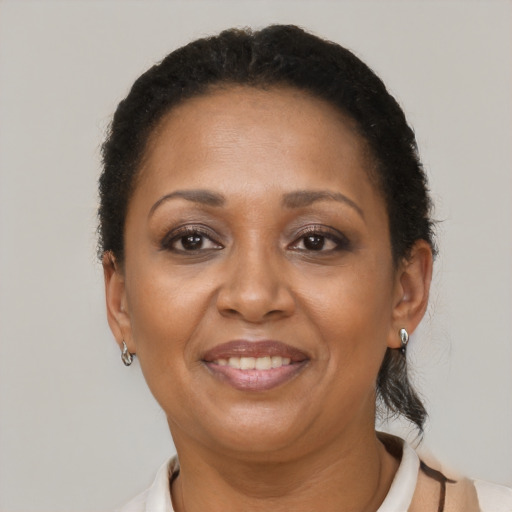 Joyful latino adult female with short  brown hair and brown eyes
