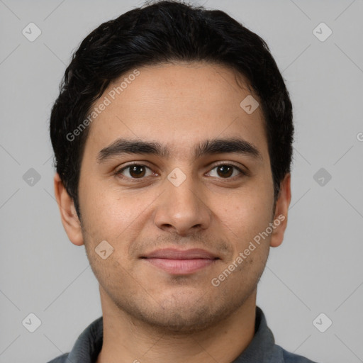 Joyful white young-adult male with short  black hair and brown eyes