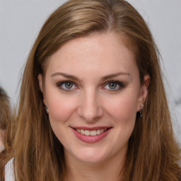 Joyful white young-adult female with long  brown hair and grey eyes