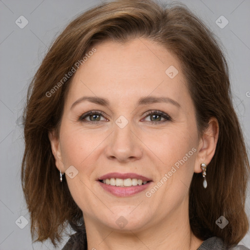 Joyful white adult female with medium  brown hair and grey eyes