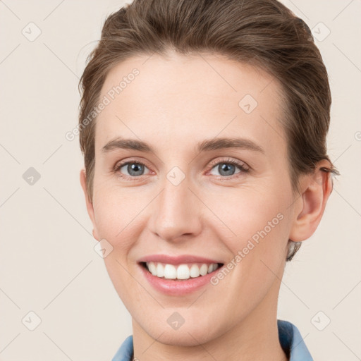 Joyful white young-adult female with short  brown hair and grey eyes