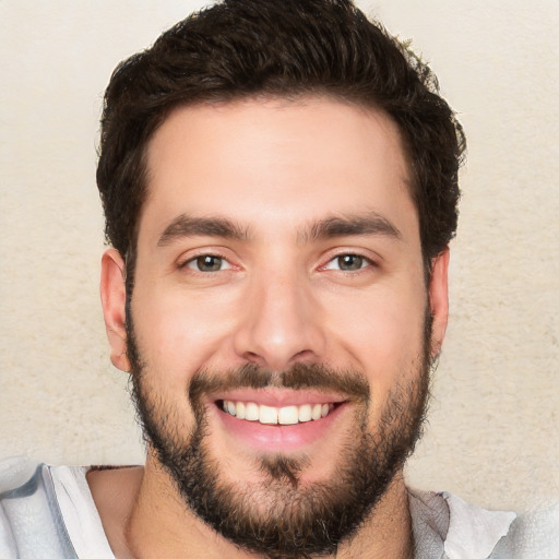 Joyful white young-adult male with short  black hair and brown eyes