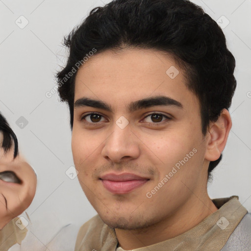 Joyful latino young-adult male with short  black hair and brown eyes