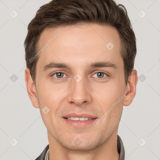 Joyful white young-adult male with short  brown hair and grey eyes