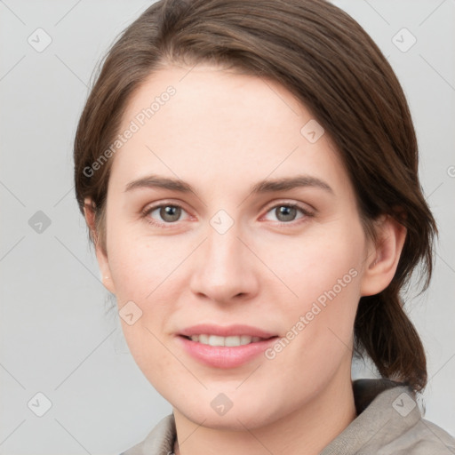 Joyful white young-adult female with medium  brown hair and grey eyes