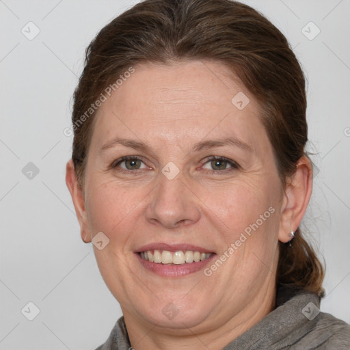 Joyful white adult female with medium  brown hair and grey eyes