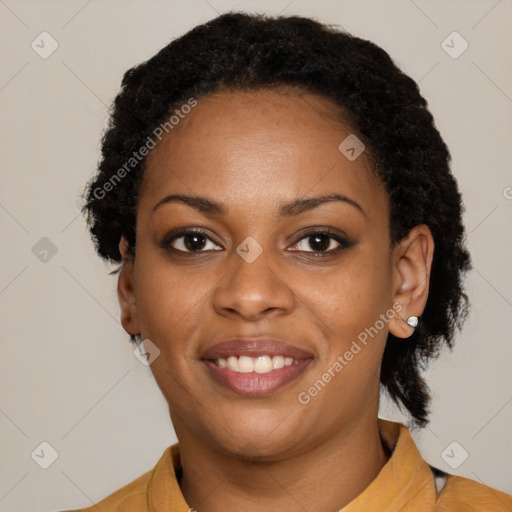 Joyful black young-adult female with short  black hair and brown eyes