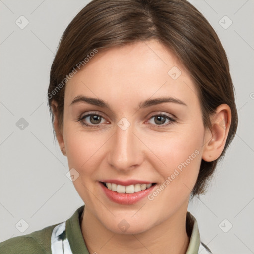 Joyful white young-adult female with medium  brown hair and grey eyes