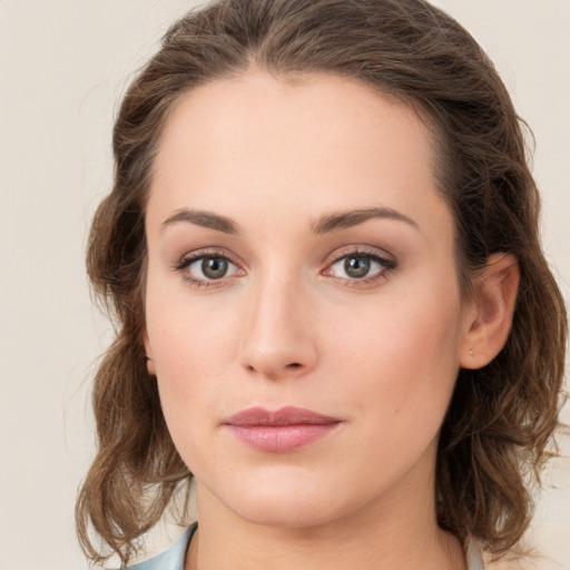 Joyful white young-adult female with medium  brown hair and green eyes