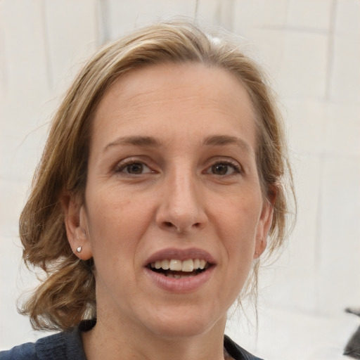 Joyful white adult female with medium  brown hair and grey eyes