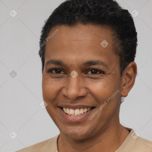 Joyful black young-adult male with short  black hair and brown eyes