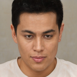 Joyful latino young-adult male with short  brown hair and brown eyes