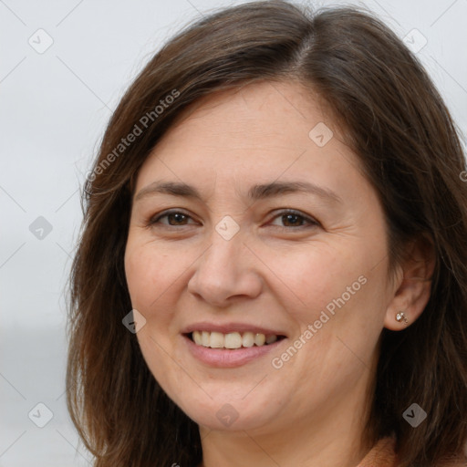 Joyful white adult female with long  brown hair and brown eyes