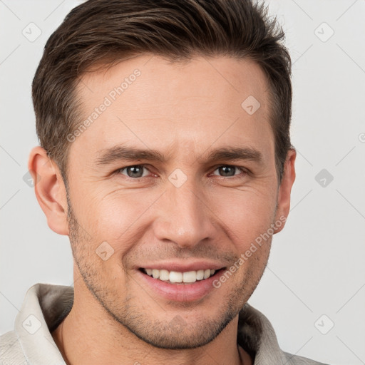 Joyful white young-adult male with short  brown hair and brown eyes