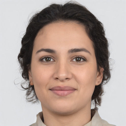 Joyful latino young-adult female with medium  brown hair and brown eyes