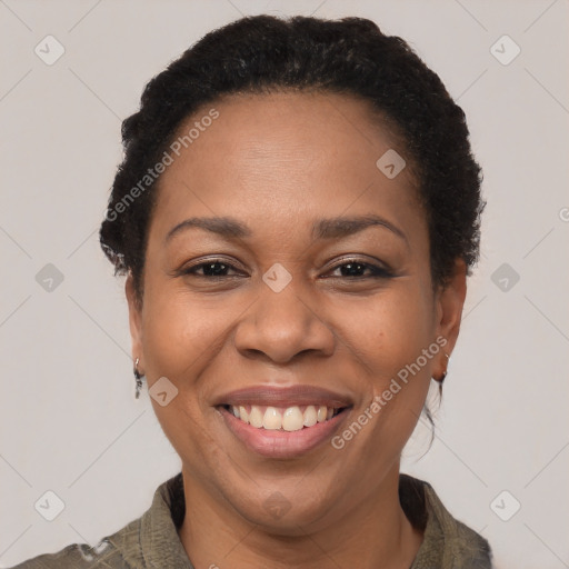 Joyful black adult female with short  black hair and brown eyes