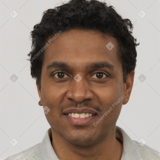 Joyful black young-adult male with short  black hair and brown eyes