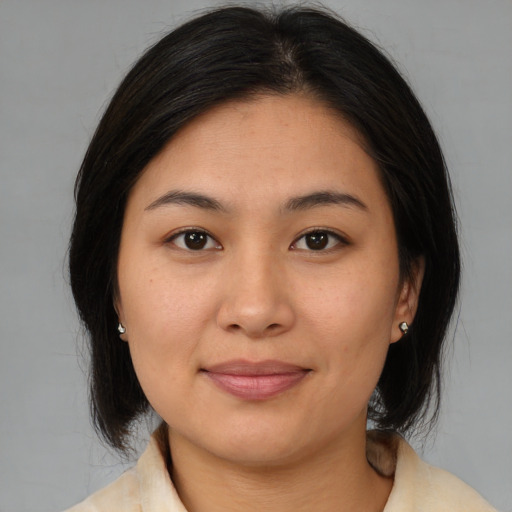 Joyful asian young-adult female with medium  brown hair and brown eyes