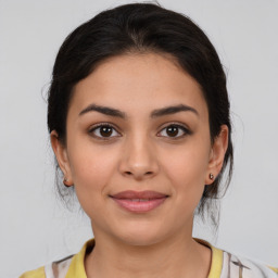 Joyful latino young-adult female with medium  brown hair and brown eyes