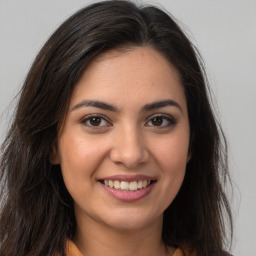 Joyful white young-adult female with long  brown hair and brown eyes