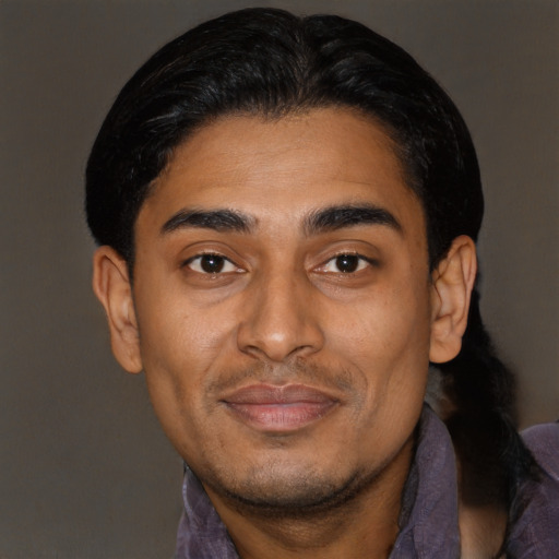 Joyful latino young-adult male with short  brown hair and brown eyes