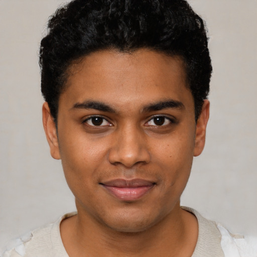 Joyful black young-adult male with short  black hair and brown eyes