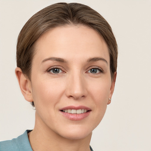 Joyful white young-adult female with short  brown hair and grey eyes