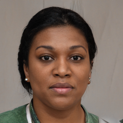 Joyful black young-adult female with short  black hair and brown eyes