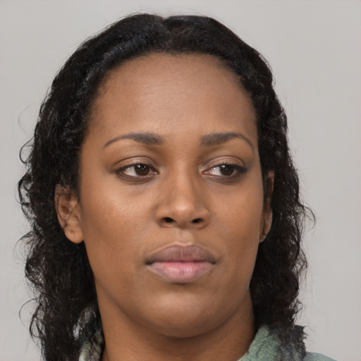 Neutral black young-adult female with long  brown hair and brown eyes