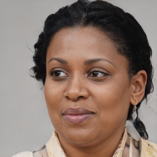 Joyful black adult female with medium  brown hair and brown eyes
