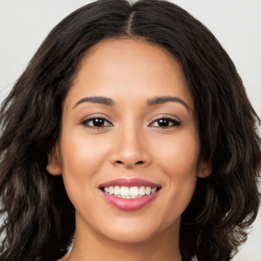 Joyful white young-adult female with long  brown hair and brown eyes