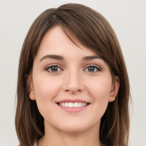 Joyful white young-adult female with long  brown hair and grey eyes